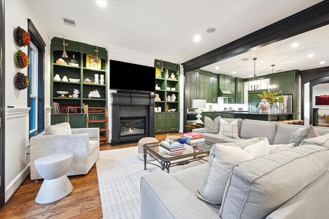 living room with hardwood / wood-style flooring and ornamental molding