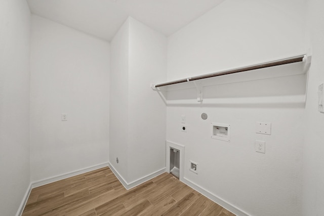 laundry room featuring light wood-style flooring, hookup for a gas dryer, laundry area, baseboards, and electric dryer hookup