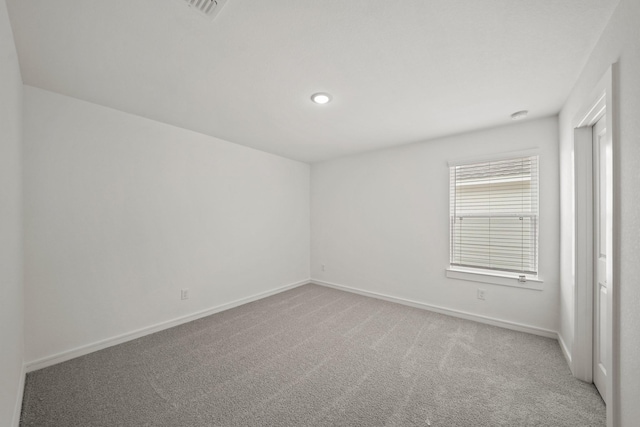 carpeted spare room with baseboards