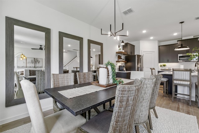 dining space featuring ceiling fan, visible vents, wood finished floors, and recessed lighting