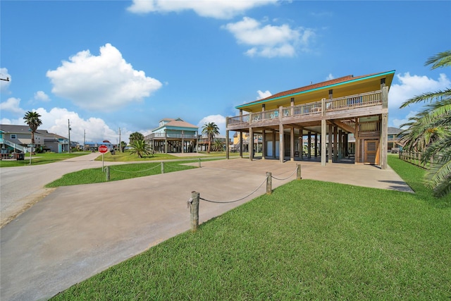 back of property featuring a carport and a yard