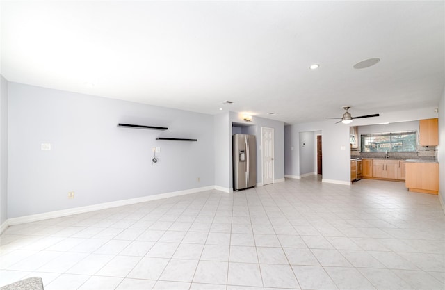 unfurnished living room featuring ceiling fan and light tile patterned floors