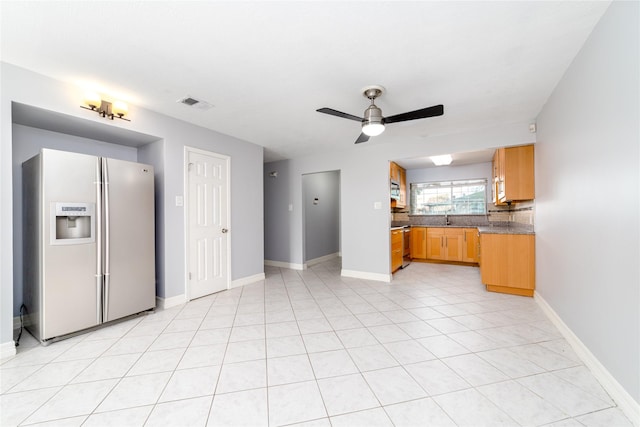 kitchen featuring sink, tasteful backsplash, range, refrigerator with ice dispenser, and ceiling fan