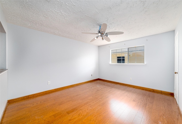 empty room featuring hardwood / wood-style floors, a textured ceiling, and ceiling fan