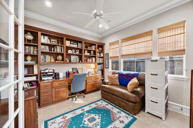 tiled office featuring built in desk, ornamental molding, and ceiling fan