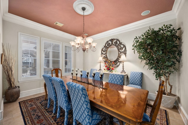 dining room with ornamental molding and a chandelier