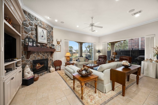 living room with crown molding, ceiling fan, and a fireplace