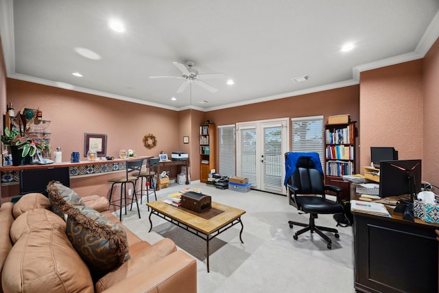 carpeted office space with crown molding and ceiling fan