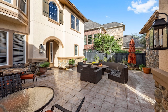 view of patio / terrace featuring an outdoor living space with a fire pit