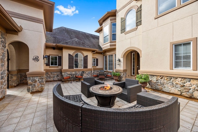 view of patio / terrace with an outdoor living space with a fire pit