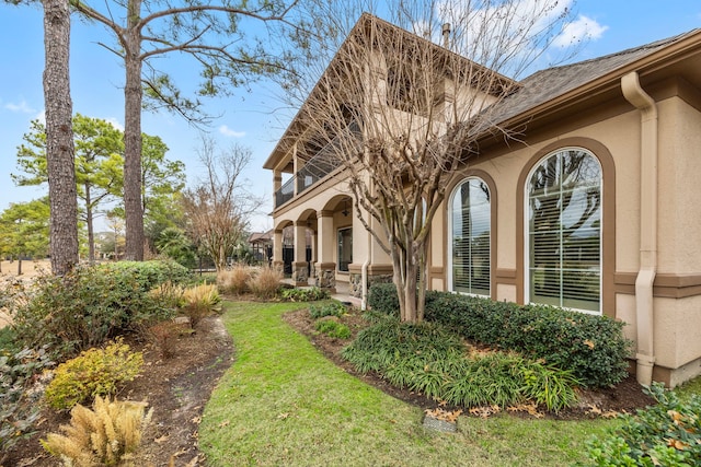 view of side of property with a yard