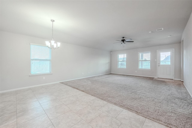 unfurnished room with light carpet and ceiling fan with notable chandelier