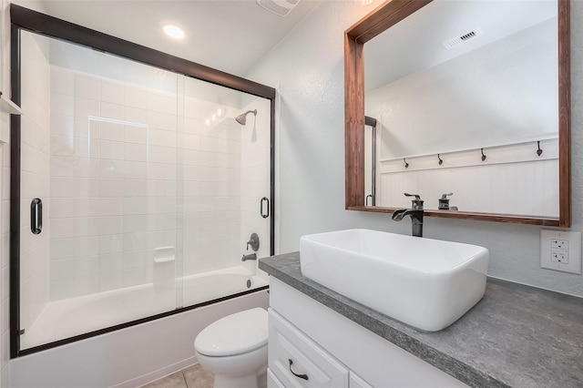 full bathroom with enclosed tub / shower combo, vanity, toilet, and tile patterned floors