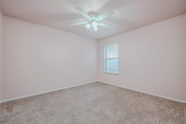 empty room featuring carpet floors and ceiling fan