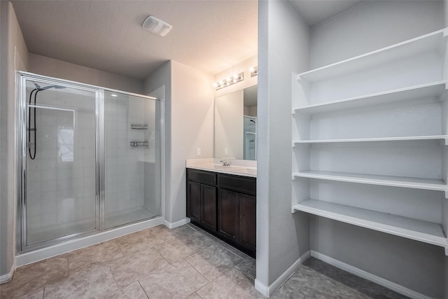 bathroom with vanity and a shower with shower door