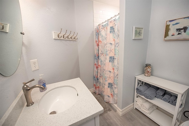 bathroom with a shower with curtain, vanity, and wood-type flooring