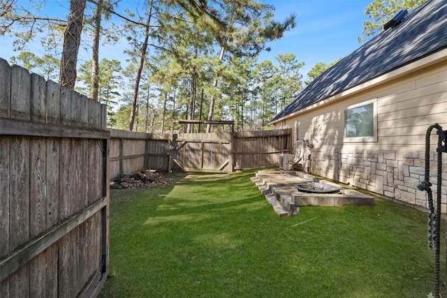 view of yard featuring a fire pit and central air condition unit