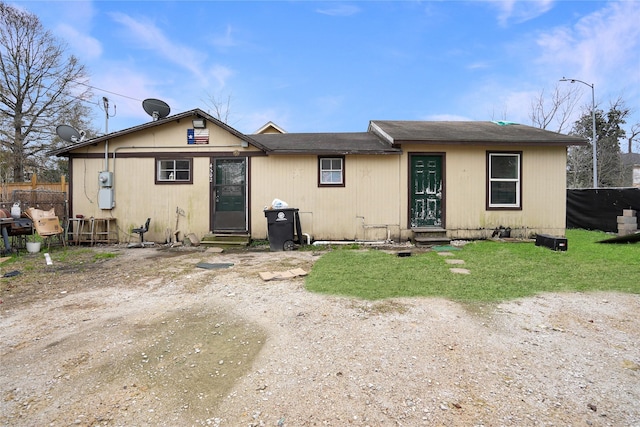 rear view of house featuring a lawn