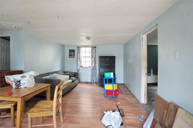 living room with wood-type flooring and a textured ceiling