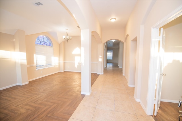 hall featuring an inviting chandelier and light parquet floors