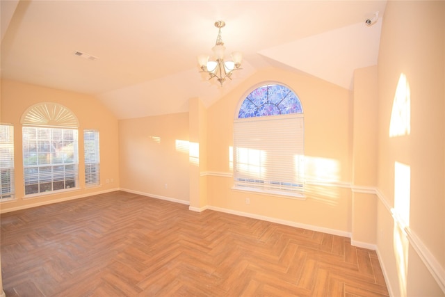 spare room featuring vaulted ceiling, baseboards, visible vents, and a notable chandelier