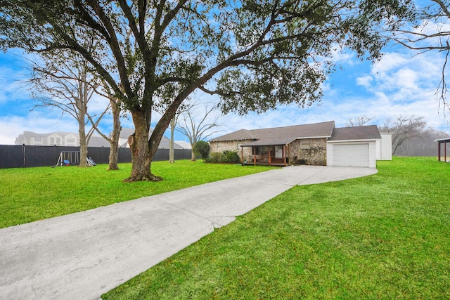 ranch-style home featuring a garage, a front lawn, and a deck