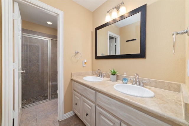 bathroom with tile patterned floors, vanity, and a shower with door