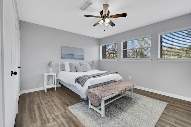 bedroom featuring ceiling fan and dark hardwood / wood-style floors