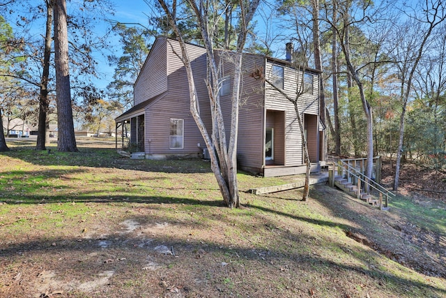 view of side of home featuring a lawn