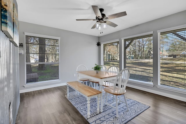 dining space with dark wood-type flooring, a wealth of natural light, and ceiling fan