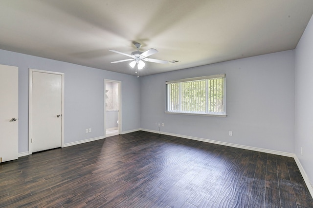 spare room featuring dark wood-type flooring and ceiling fan