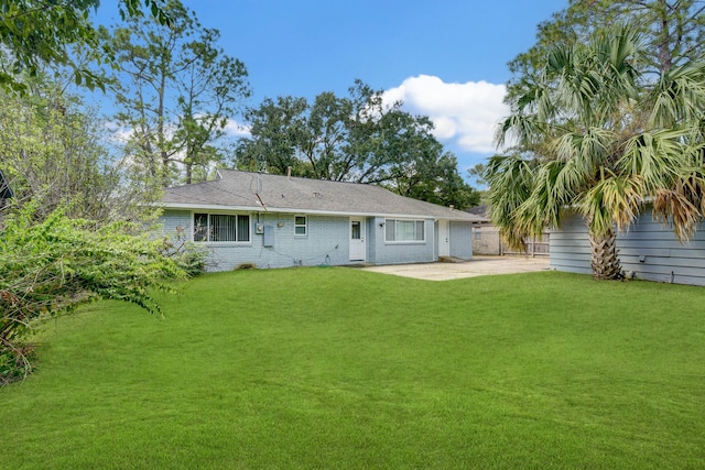 rear view of property featuring a yard and a patio