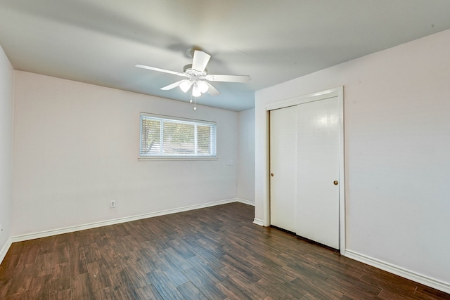 unfurnished bedroom with dark hardwood / wood-style flooring, a closet, and ceiling fan