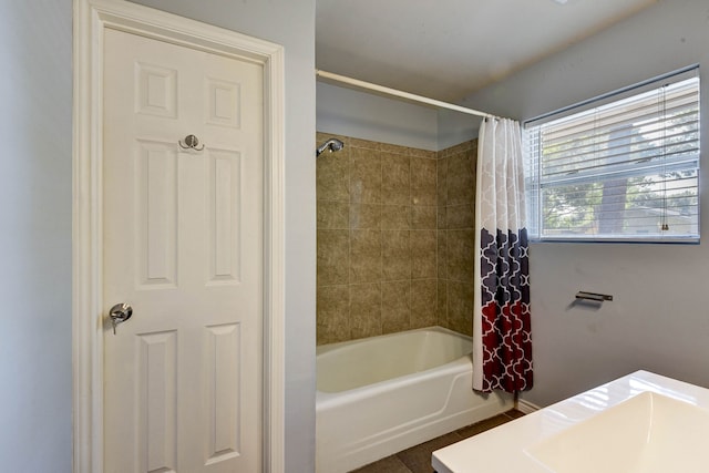 bathroom with tile patterned floors and shower / bath combo with shower curtain