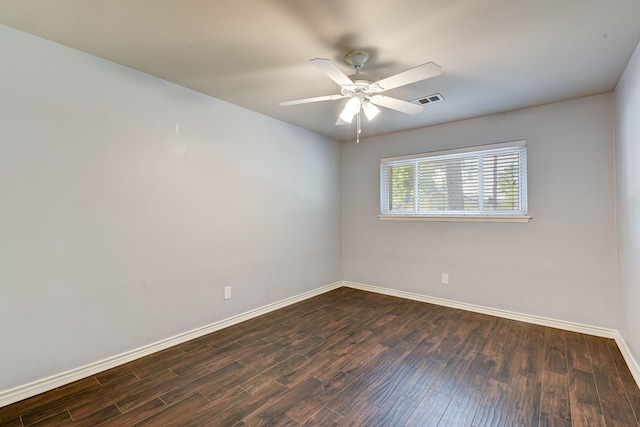 empty room with dark hardwood / wood-style floors and ceiling fan