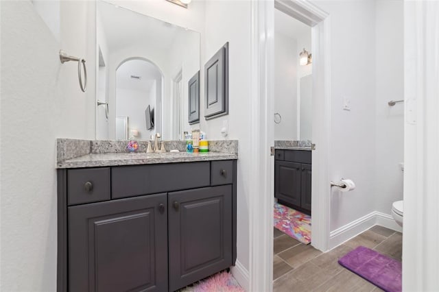 bathroom with vanity and toilet