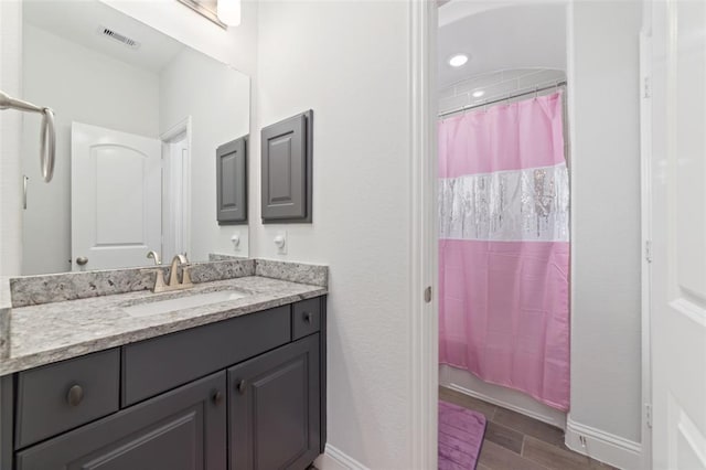 bathroom with vanity and hardwood / wood-style floors