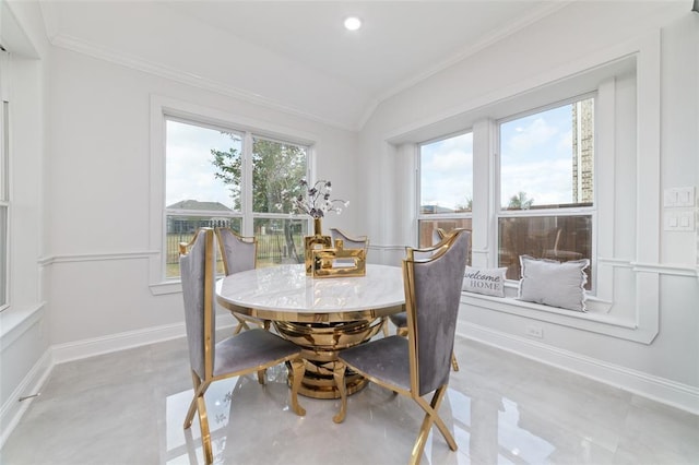 dining room with lofted ceiling and crown molding