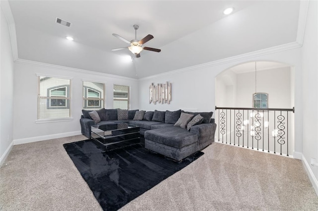 carpeted living room featuring ornamental molding, lofted ceiling, and ceiling fan