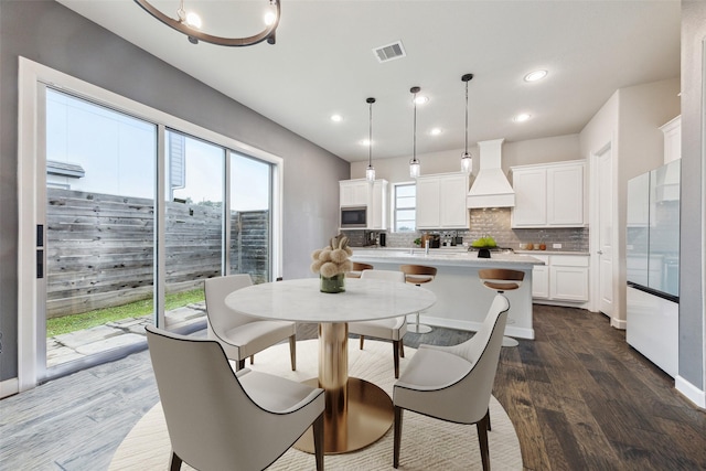 dining space with dark hardwood / wood-style flooring