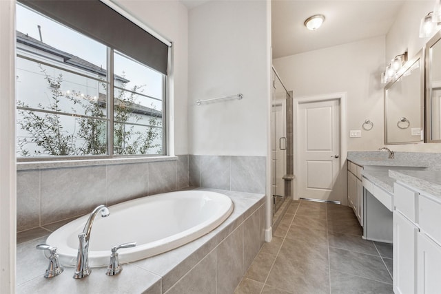 bathroom with tile patterned flooring, vanity, and plus walk in shower