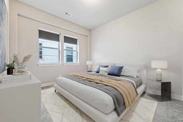 bedroom with light colored carpet