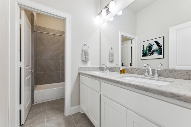 bathroom featuring tiled shower / bath, vanity, and tile patterned flooring