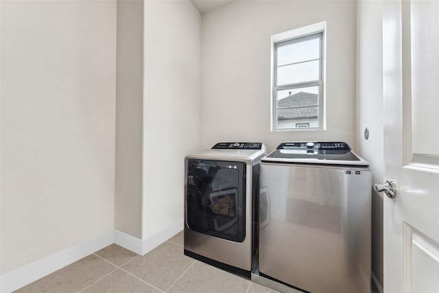 laundry room with light tile patterned floors and washing machine and clothes dryer