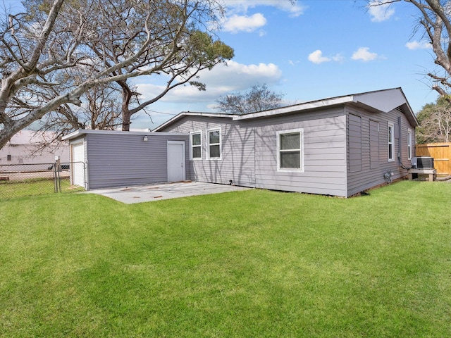 rear view of house with a yard, central AC, and a patio area