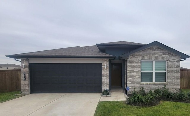 view of front of property with a garage and a front yard