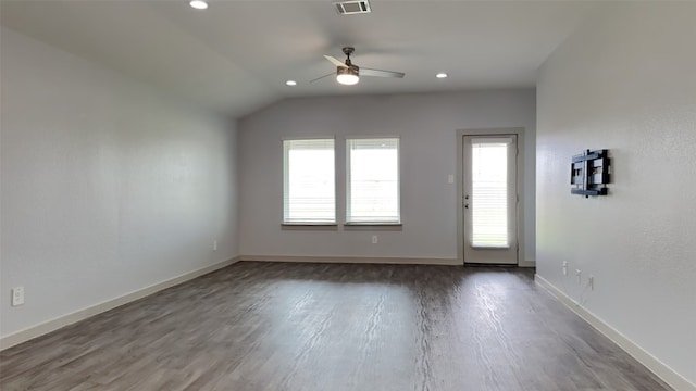 unfurnished room featuring dark hardwood / wood-style flooring, vaulted ceiling, and ceiling fan