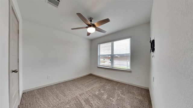 carpeted spare room with ceiling fan