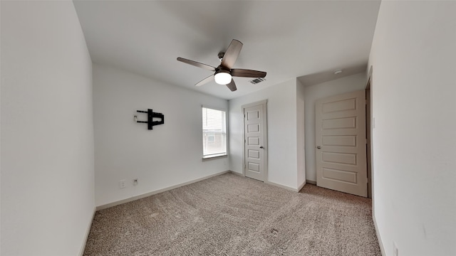 unfurnished bedroom featuring light colored carpet and ceiling fan