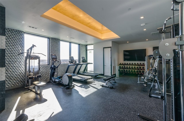 exercise room with a tray ceiling